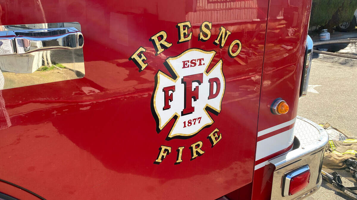 A Fresno Fire Department truck at the scene of a fire. Generic Fresno Fire Department photo art that is easier to search.